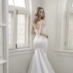 Elegant white satin mermaid wedding dress with open back and fine button details
