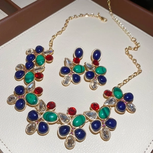 Macro detail of vintage water-drop jewelry set with multi-colored gems in a premium box
