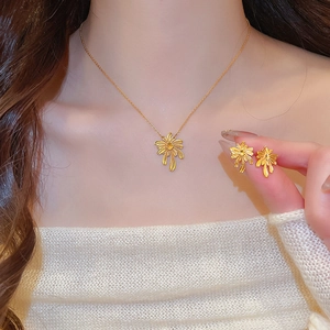 Detail of elegant gold plated firework necklace and earrings set on model