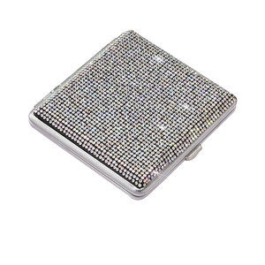 Macro side view of luxury slim stainless steel cigarette case with sparkling rhinestones