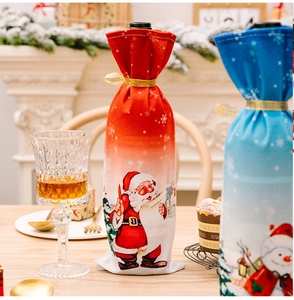 Detail of Christmas wine bottle covers with Santa and snowman patterns on a festive table