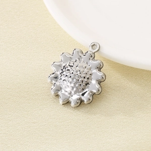 Polished 304 stainless steel sunflower pendant detail with textured center and top ring