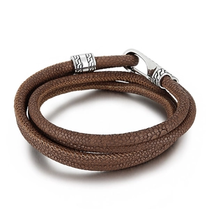 Brown stingray skin leather wrap bracelet with engraved silver metal clasp on white background