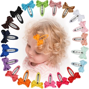 Detailed collection of colorful 4-inch velvet Christmas hair bows on snap clips for kids