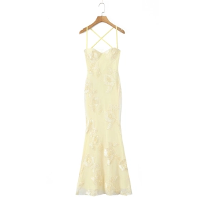 Close-up of yellow fishbone corset dress featuring intricate 3D floral embroidery and lace
