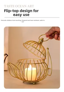Detail of golden iron teapot-shaped candle holder with hollow lines and a flip-top lid