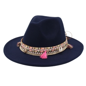 Detailed shot of ethnic navy felt fedora with pink tassels, shells and woven band
