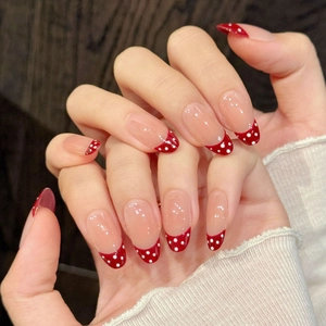 Burgundy polka dot French tip almond press-on nails with a natural sheer pink base