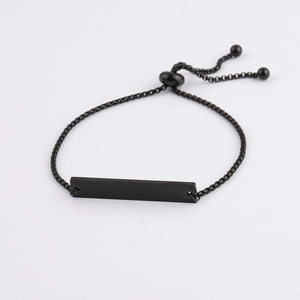 Macro view of adjustable black stainless steel bar bracelet with bolo chain and beads