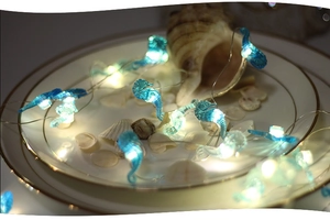 Macro shot of seahorse LED string lights with translucent blue ocean theme pendants