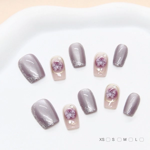 Handmade lilac cat eye press-on nails with butterfly art and rhinestone accents