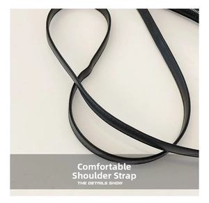 Detail of wide black leather strap with precise stitching for the cleaver handbag