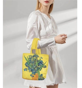 Model showing a yellow canvas bucket bag featuring Van Gogh's Irises oil painting print