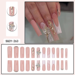 Long champagne gold bow press-on nails with luxury rhinestones and silver accents