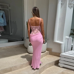 Pink backless lace patchwork maxi dress for summer vacations on sunlit stairs