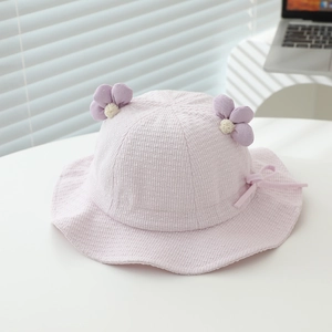 Detail of light purple seersucker baby sun hat with floral accents and side ribbon ties