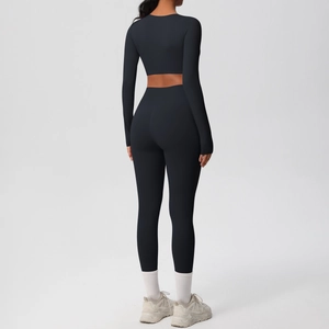 Rear view of sleek black yoga set featuring long sleeve crop top and high waisted leggings