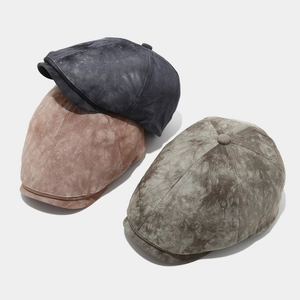 Detail of vintage octagonal newsboy caps in washed grey, brown and olive green fabrics