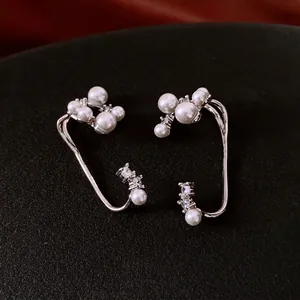 Elegant silver ear cuffs with white pearls and zircons for a luxury fashion jewelry look