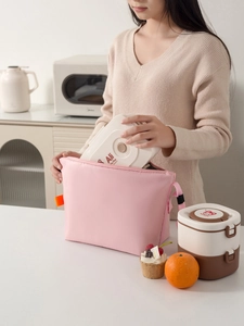 Pink insulated lunch bag with Ali the Fox layered bento box in a home kitchen setting