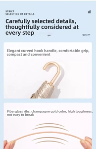 Champagne gold umbrella detail showing the curved handle and flexible fiberglass ribs