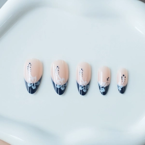 Blue French almond press-on nails with white hibiscus flower art and nude base