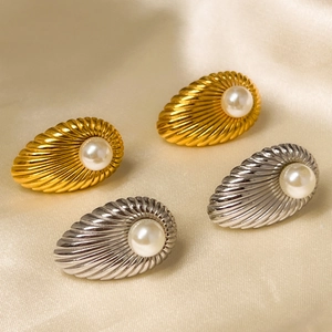 Elegant 18K gold and silver waterdrop earrings with pearls on silk fabric background