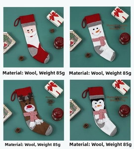 Detail of four knitted Christmas stockings with 3D Santa, snowman, elk and penguin patterns