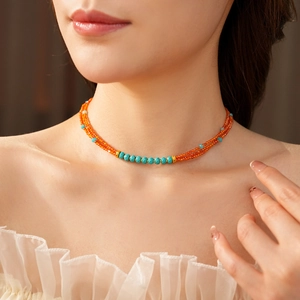 Close-up of vintage multi-layer necklace with orange agate and turquoise beads