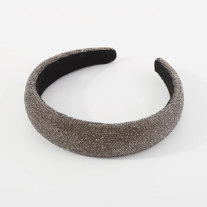 Macro shot of charcoal grey crystal rhinestones on a thick padded velvet headband