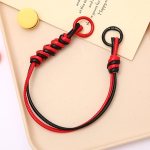 Detail of woven black and red PU leather phone strap with metal spring clasp and O-ring