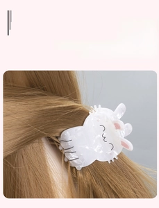 Cute pearl white rabbit hair claw clip made of acrylic on light brown hair for women