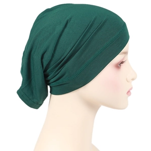 Detailed side view of dark green elastic modal hijab inner cap with natural pleats