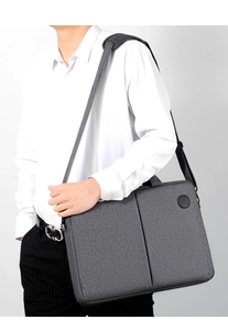Business laptop briefcase in dark grey fabric with adjustable shoulder strap on model