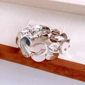 Detailed view of wide silver S-shaped metal plates with glossy textured finish