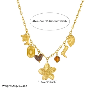 Vintage gold necklace with diverse acrylic charms including heart, flower and boot charms