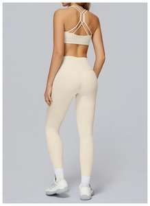 Detailed back view of criss-cross yoga bra and high-waisted leggings in beige matte fabric
