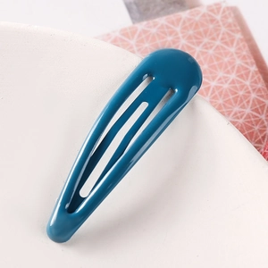 Macro shot of 5cm peacock blue metal snap hair clip with smooth glossy lacquer finish