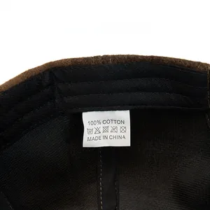 Close-up of internal 100% cotton fabric and wash care label on a plaid baseball cap