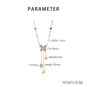Detail view of gold butterfly pendant with rhinestones, pearls and tassel chain specifications