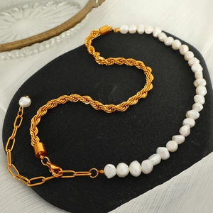 Baroque pearl and gold twisted rope chain necklace set on a professional display