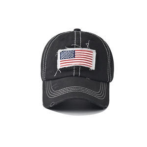 Detail of vintage distressed black cotton baseball cap with American flag embroidery