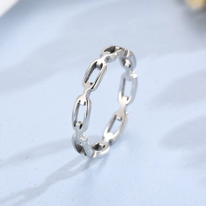 Macro shot of silver stainless steel chain link ring with interlocking geometric design