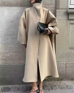 Close-up of a beige high-collar wool coat with stylish snap buttons and loose fit design