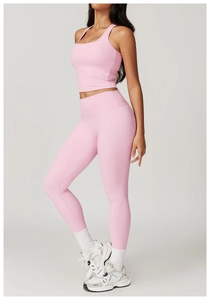 Detailed side view of pink high-waist yoga set with racerback top and elastic leggings