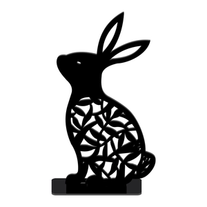 Detail of laser-cut black bunny silhouette with leaf patterns on a wooden stand