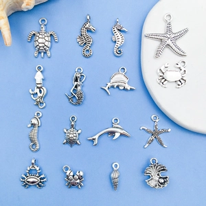Collection of 16 silver ocean-themed metal charms including seahorses and starfish