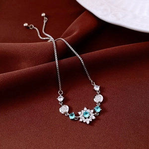 Macro shot of adjustable silver snowflake bracelet with blue and white zircons