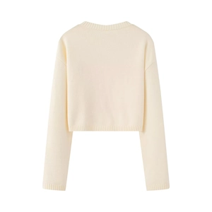 Detail showing the back view of this cream-white cropped knit sweater with ribbed cuffs