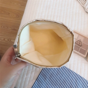 Detailed interior of the jacquard rose cosmetic bag showing gold zipper and spacious lining